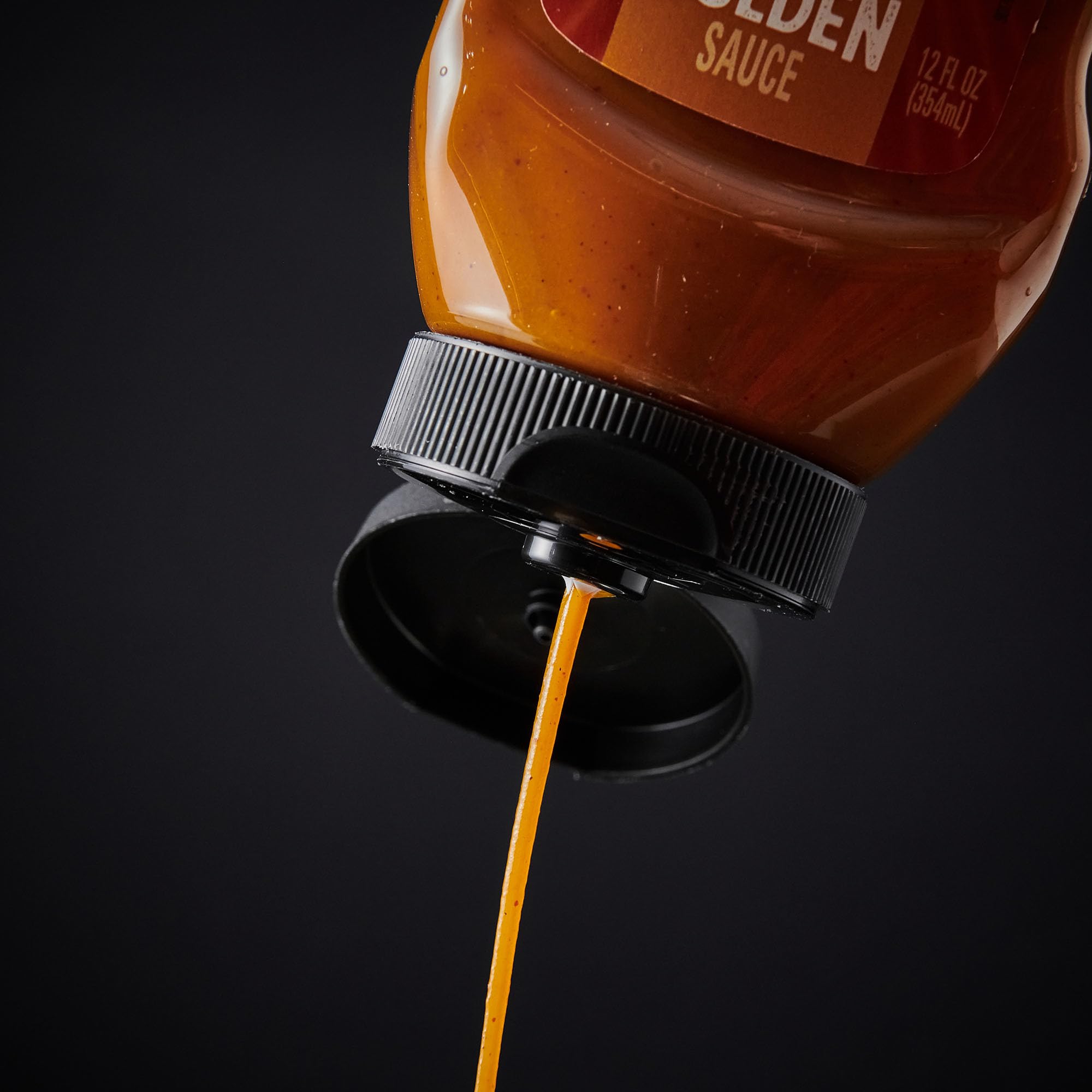 Open bottle of Frank's RedHot Dip'N Golden Sauce ready to dip