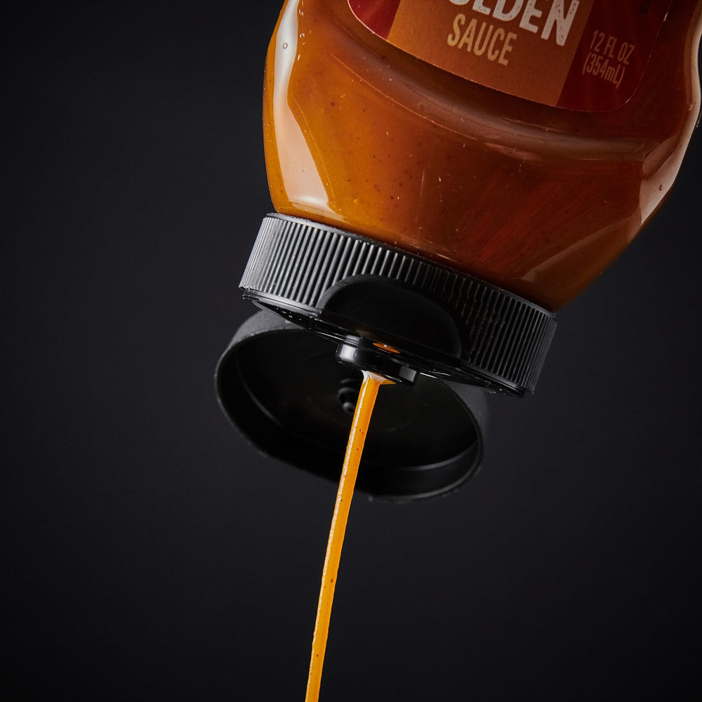 Open bottle of Frank's RedHot Dip'N Golden Sauce ready to dip