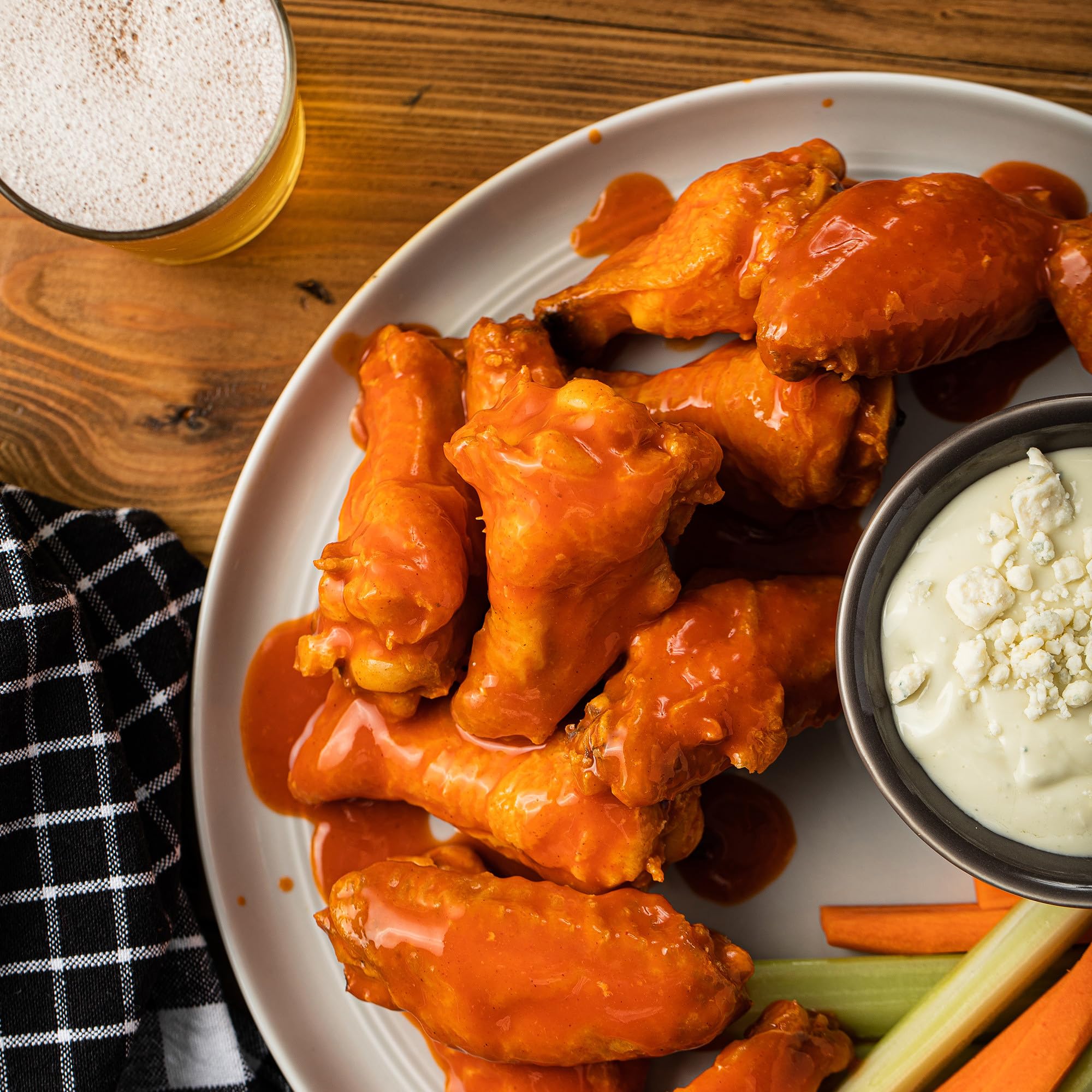 Franks RedHot Buffalo Wings sauce poured over wings for intense buffalo heat