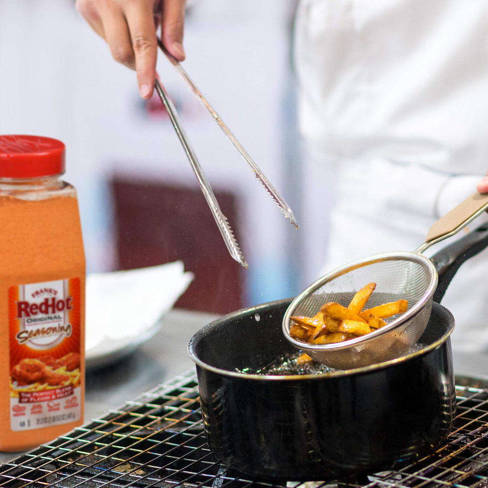 Franks RedHot Original Seasoning at the kitchen counter signals ready-to-use convenience.