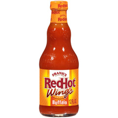 Frank's RedHot Buffalo Wings Sauce bottle pouring on wings for bold heat.
