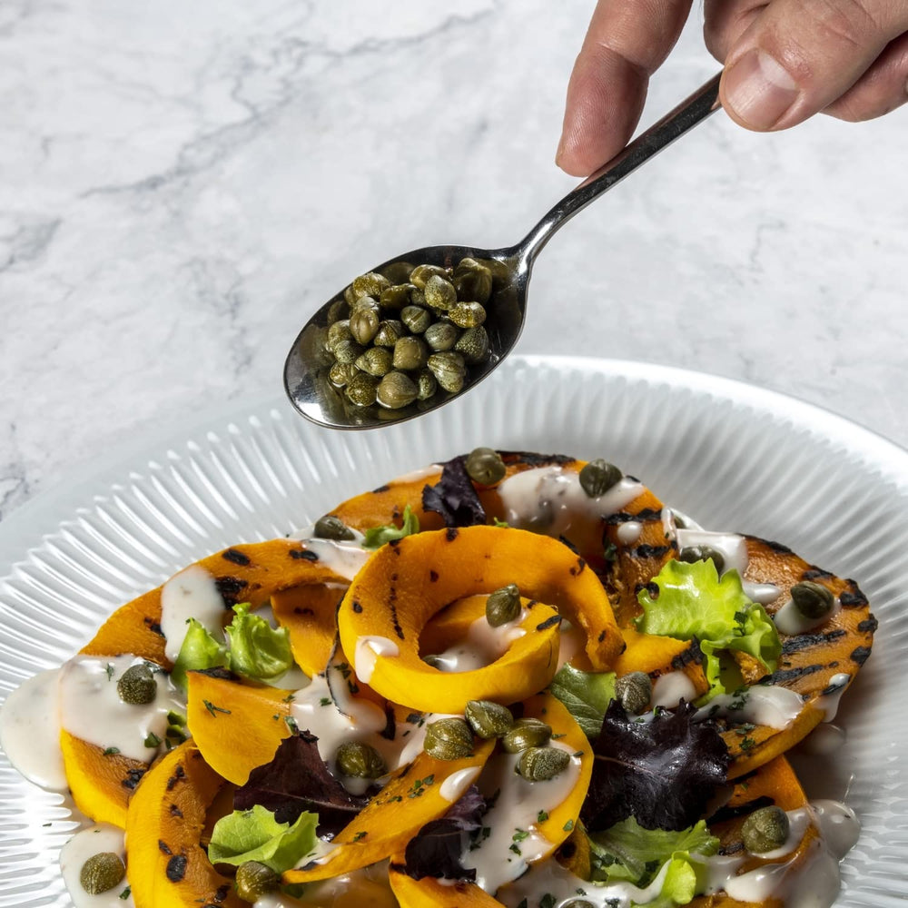 Salad with Fratelli D'Amico capers adds tangy Mediterranean brightness.