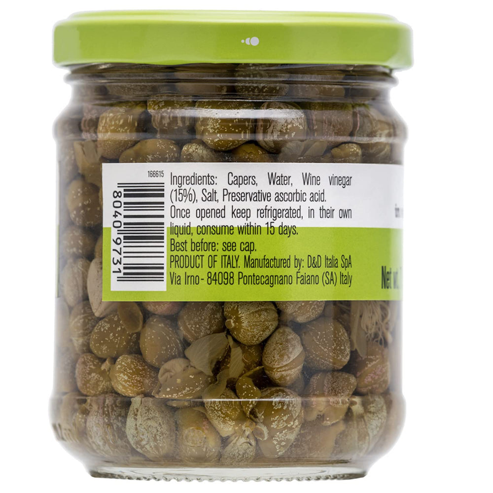 FRATELLI D'AMICO capers on a spoon over a dish for quick flavor boost.