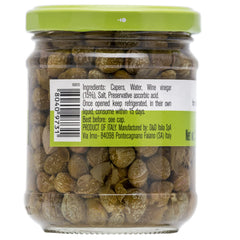 FRATELLI D'AMICO capers on a spoon over a dish for quick flavor boost.