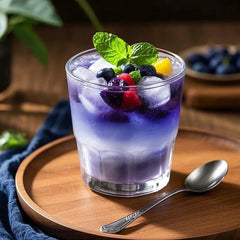 Fraunitsh color-changing cocktail with citrus and butterfly pea powder