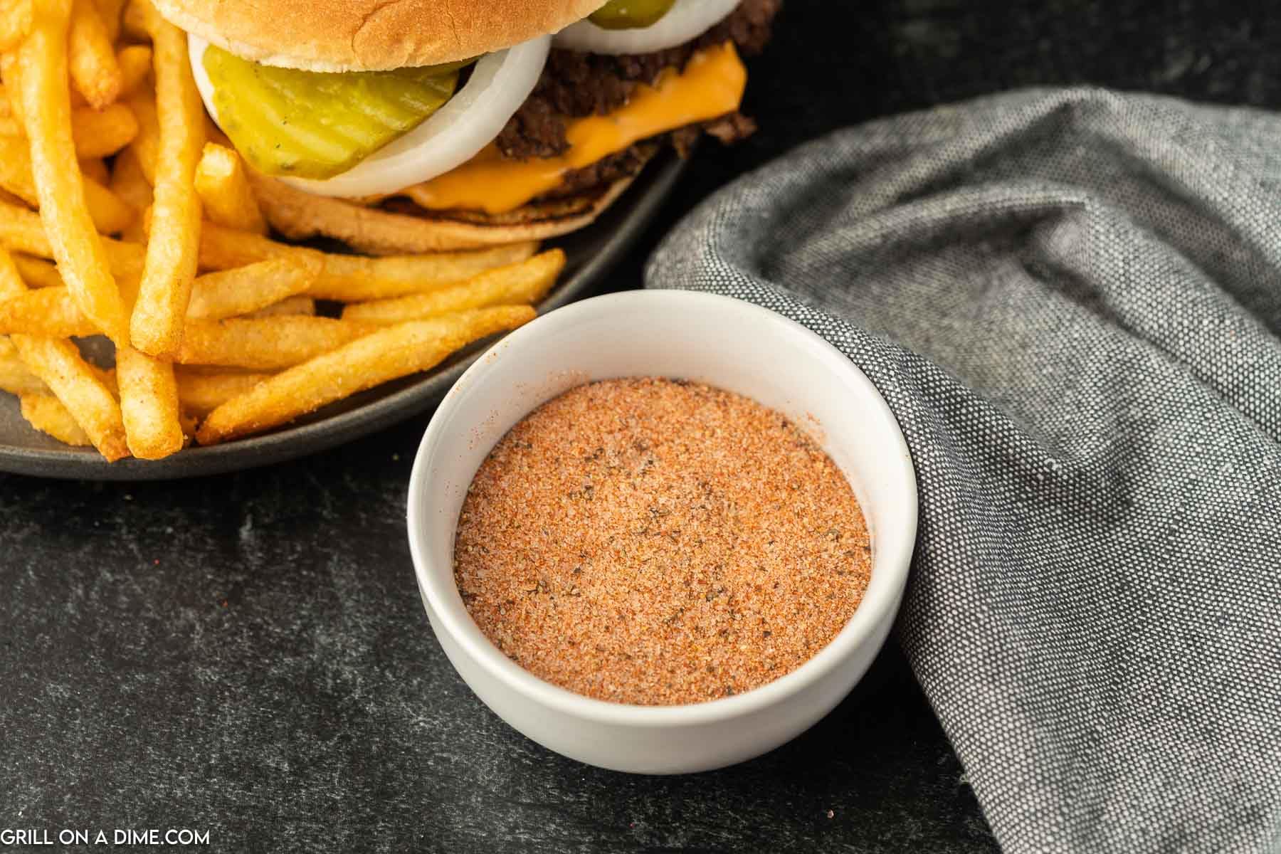 Plate featuring steakburger and fries seasoned with Freddy's Sreakhouse for crave-worthy taste