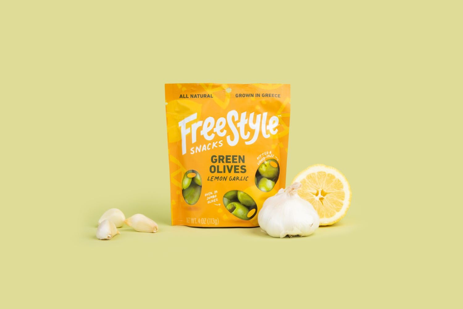 Freestyle Snacks green olives lemon garlic jar opened, convenient 4-ounce snack pack.
