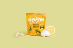 Freestyle Snacks green olives lemon garlic jar opened, convenient 4-ounce snack pack.