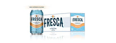 Fresca Peach Soda bottle beside a glass, showcasing refreshing peach flavor.