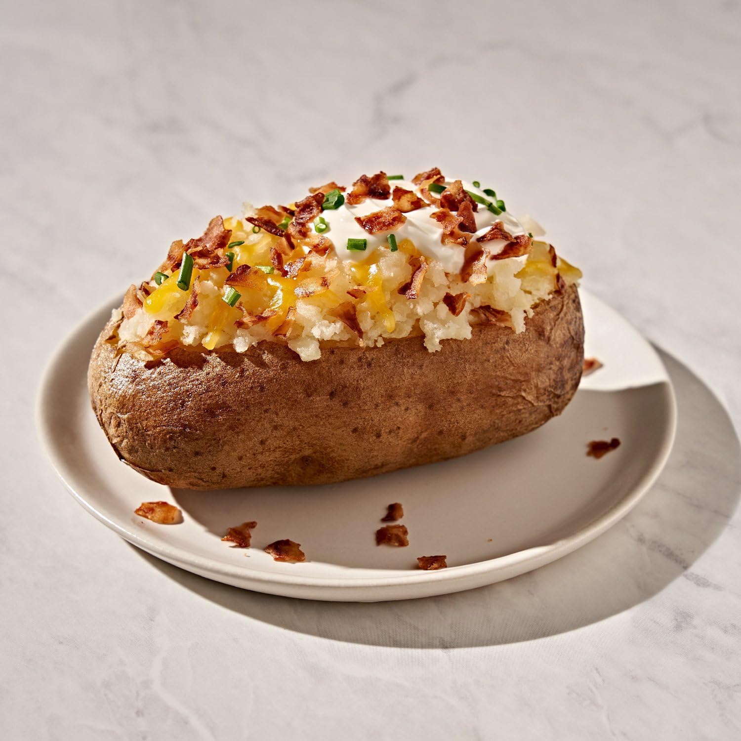 Fresh Gourmet Bacon-Less Bits kitchen scene illustrates versatile plant-based topping.