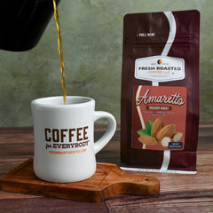 Fresh Roasted Coffee Amaretto cup steaming with inviting aroma for relaxing break.