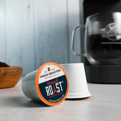 Fresh Roasted Coffee French Roast 96 pods closeup on beans highlights rich aroma