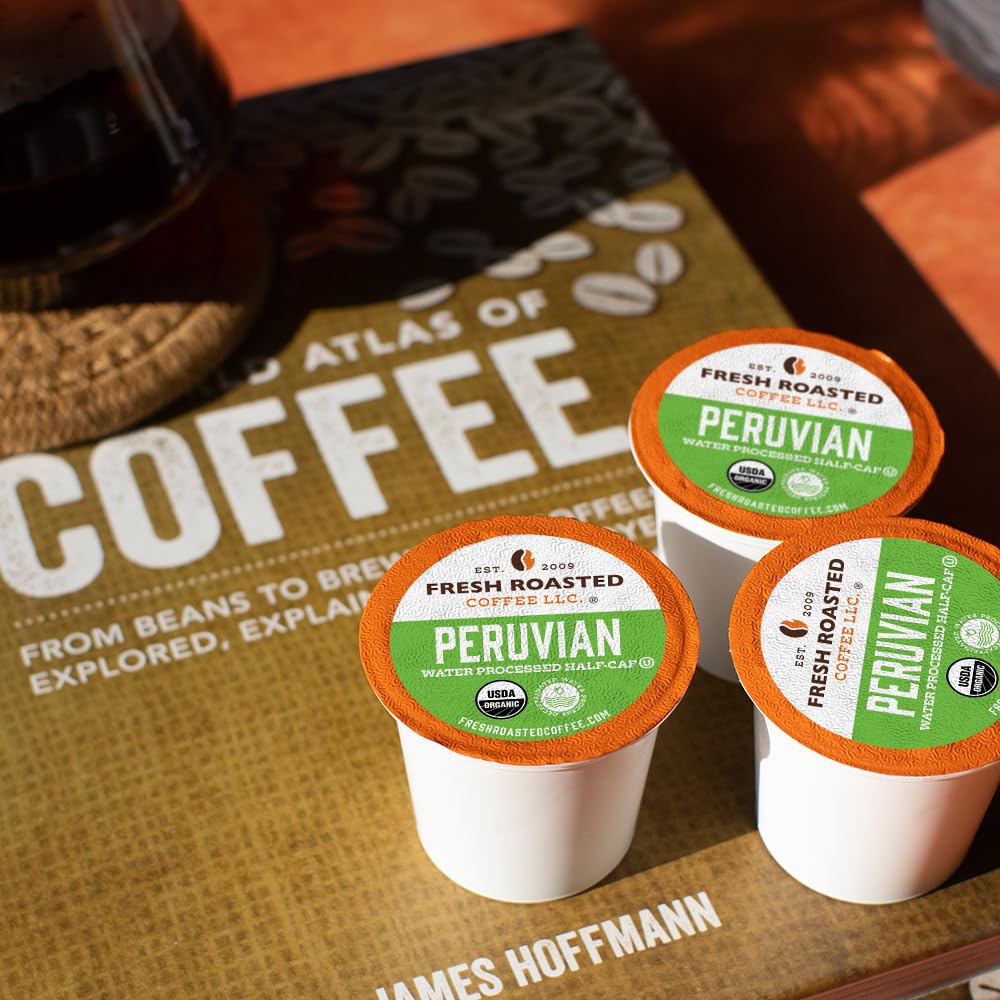 Fresh Roasted Coffee Peru Half Caf pod in pack beside a K-Cup brewer.