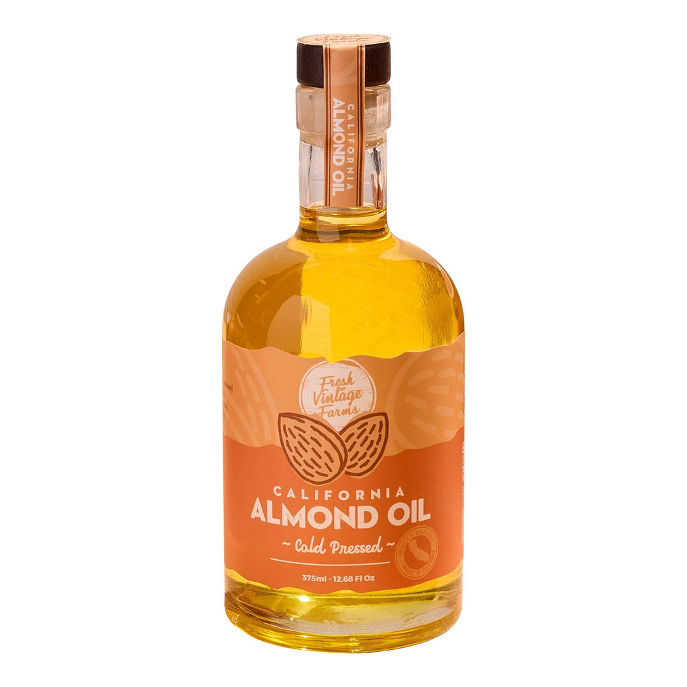 Fresh Vintage Farms almond oil bottle pouring for cooking and dressings.