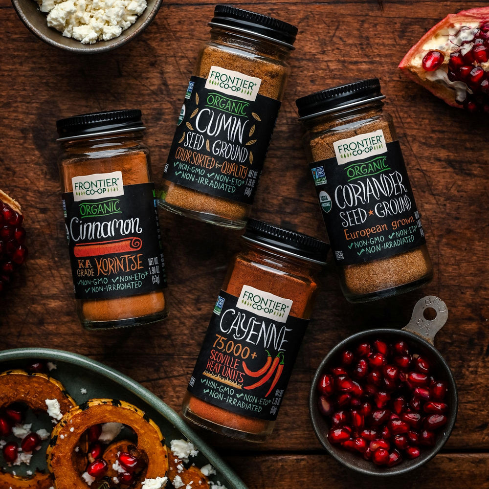 Frontier Co-op Cayenne spice dust on spoon showcases vibrant color and peppery aroma.