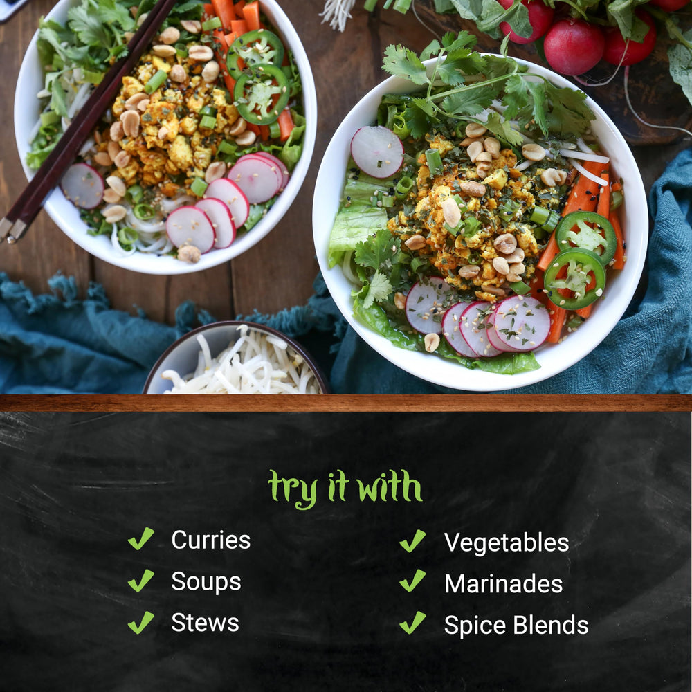 Frontier Co-op curry powder blending into a steaming curry dish with vibrant color.