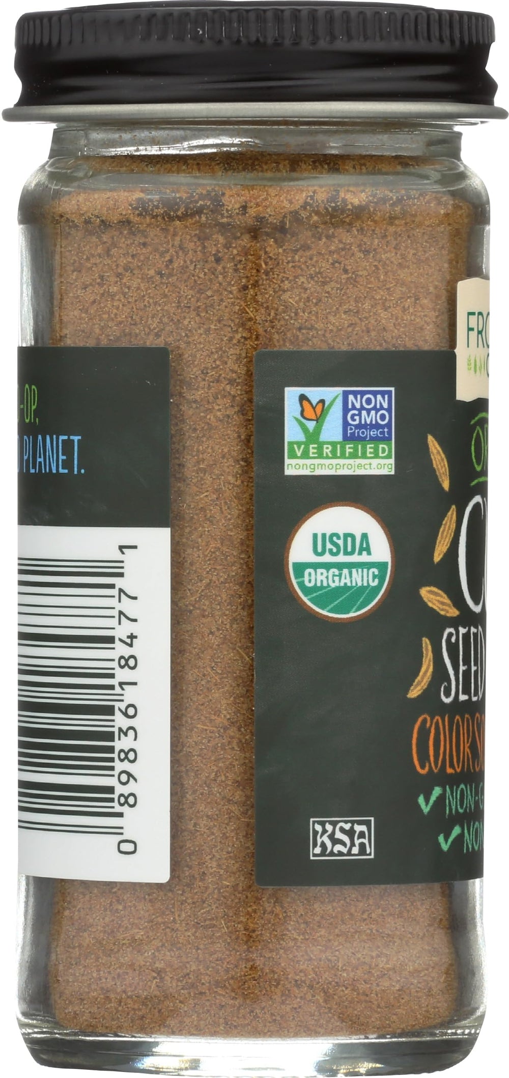 Frontier Co-op organic ground cumin in a wooden spoon over a skillet.
