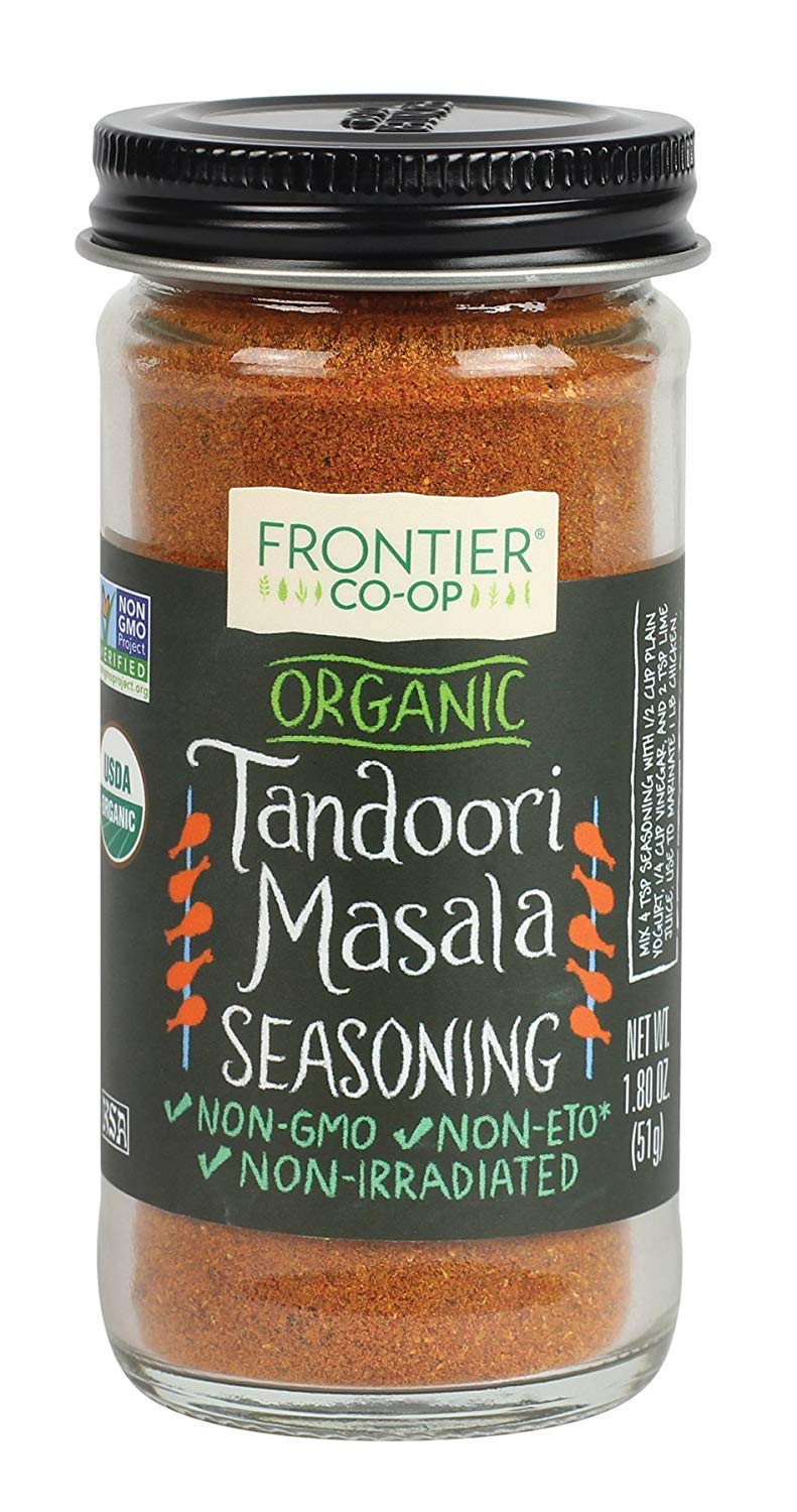 Frontier Co-op Tandoori Masala seasoning bottle pour, ideal for grilling and marinades.