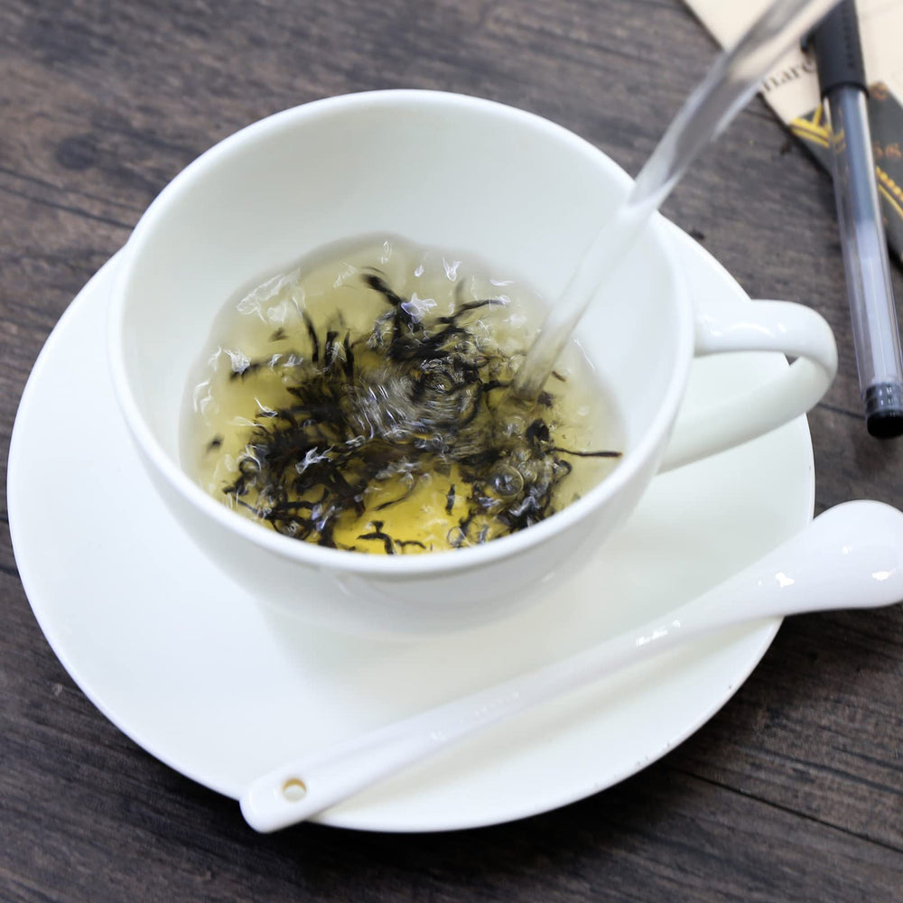 Brewed amber liquor from FullChea Golden Monkey Tea delivering a smooth, mild flavor.