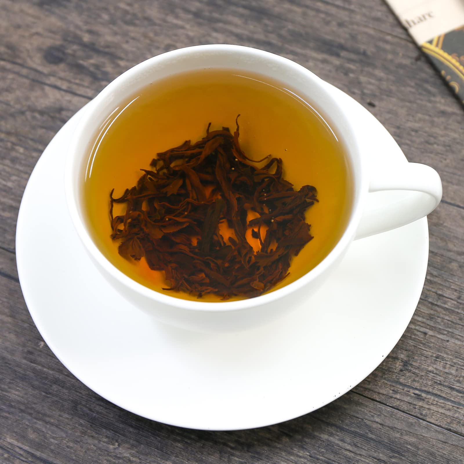 Steam rising from FullChea Golden Monkey Tea cup inviting a rich aroma.