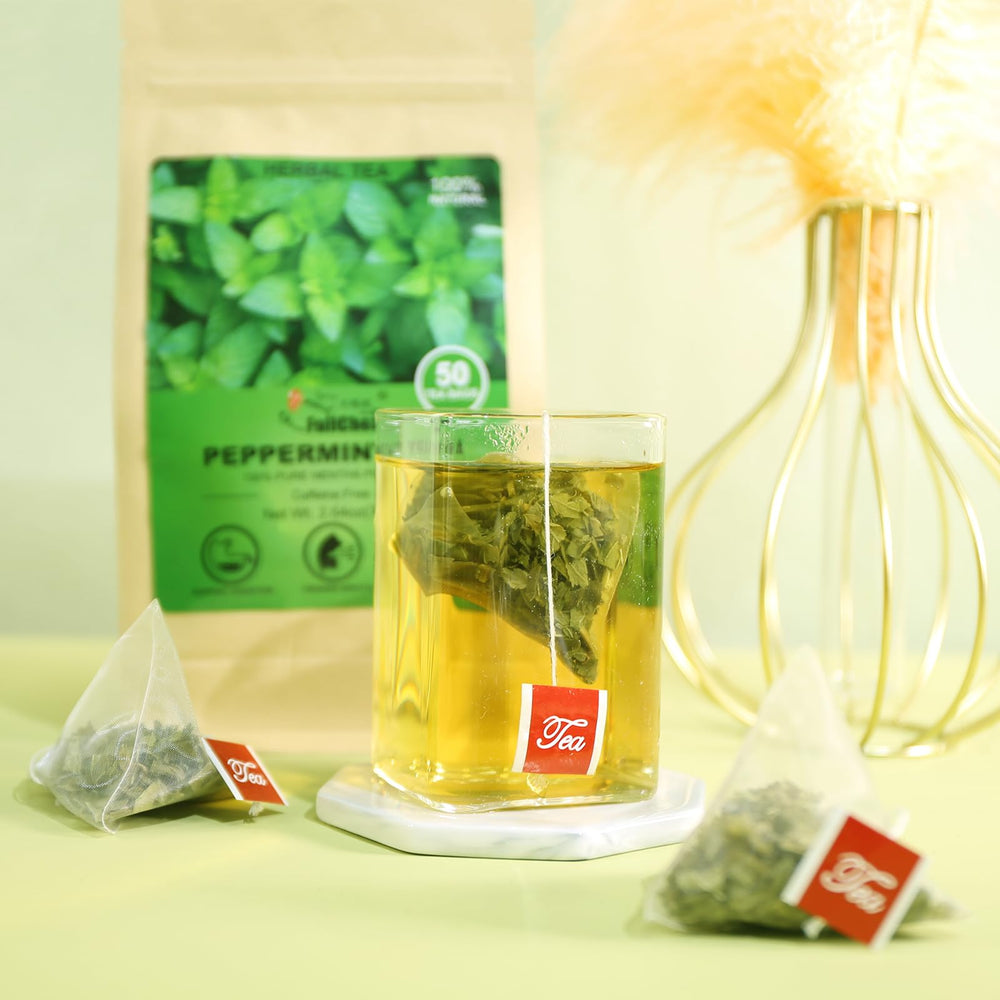 FullChea peppermint tea bag steeping in hot water for flavor.
