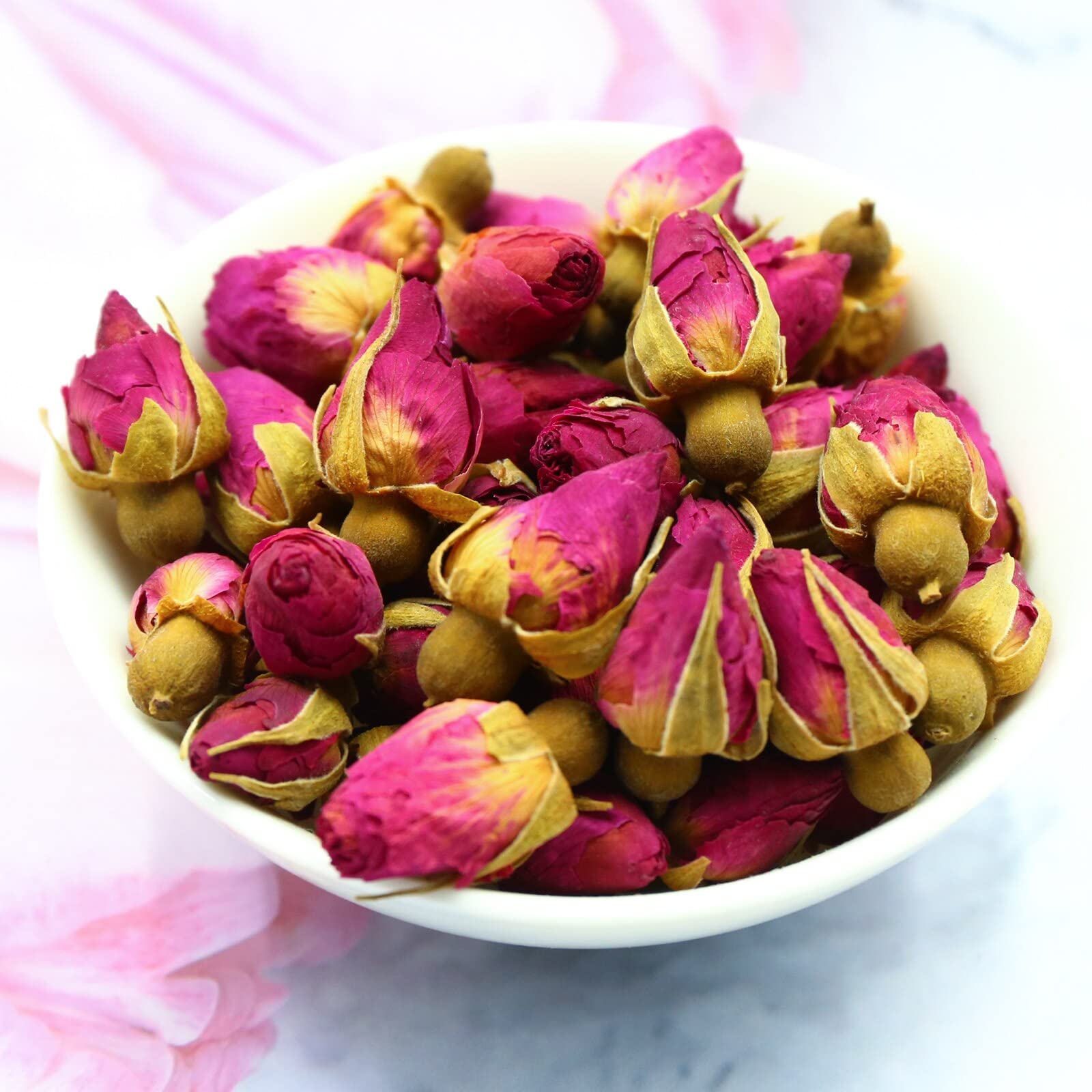 FullChea rose buds tea in cup, aromatic and edible.