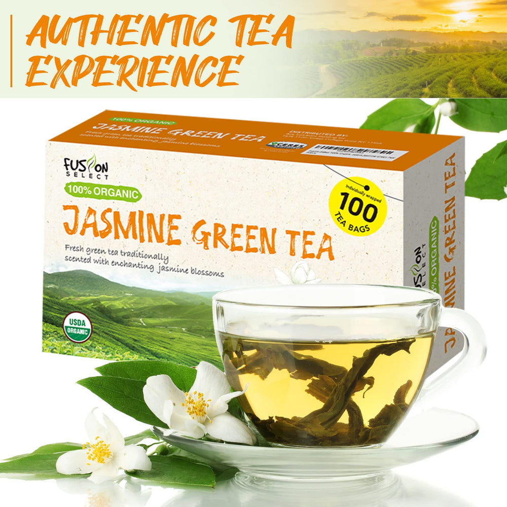 Fusion Select Organic Jasmine Green Tea leaves with jasmine blossoms close-up.
