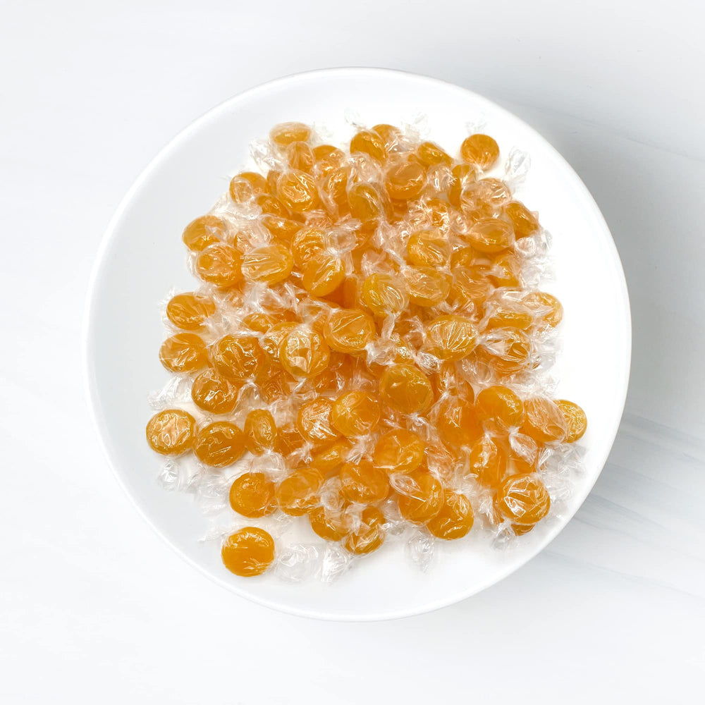 Fusion Sweets Butterscotch yellow candies in a ready-to-serve bulk display.