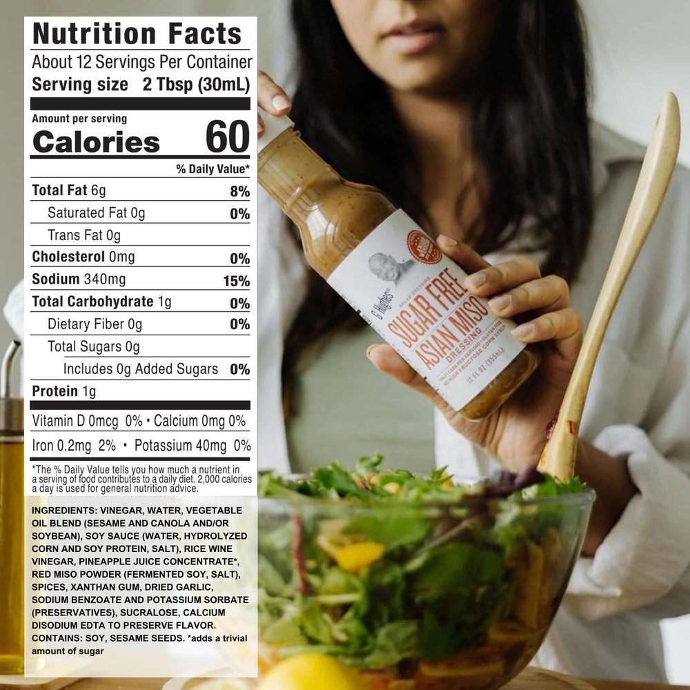 G Hughes Sugar Free Asian Miso Dressing being poured over greens for a low-carb option