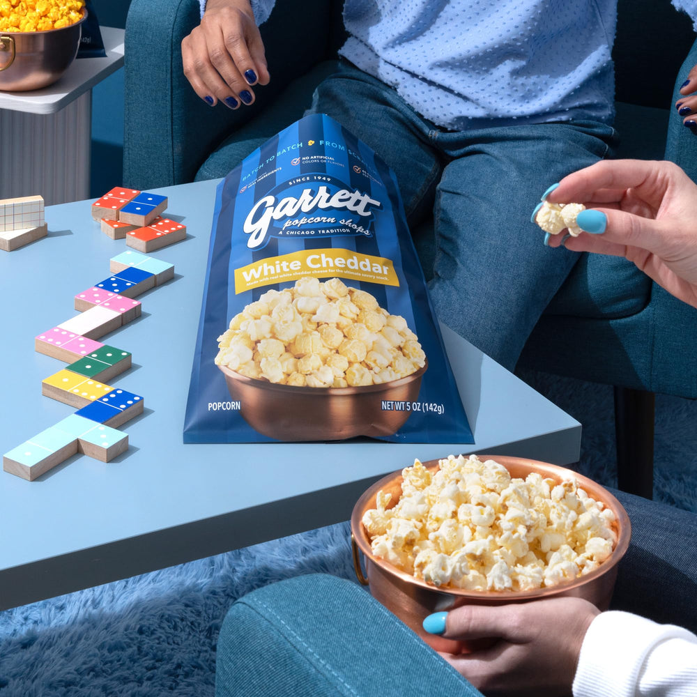 Garrett Popcorn White Cheddar added to party spread for a gourmet twist.