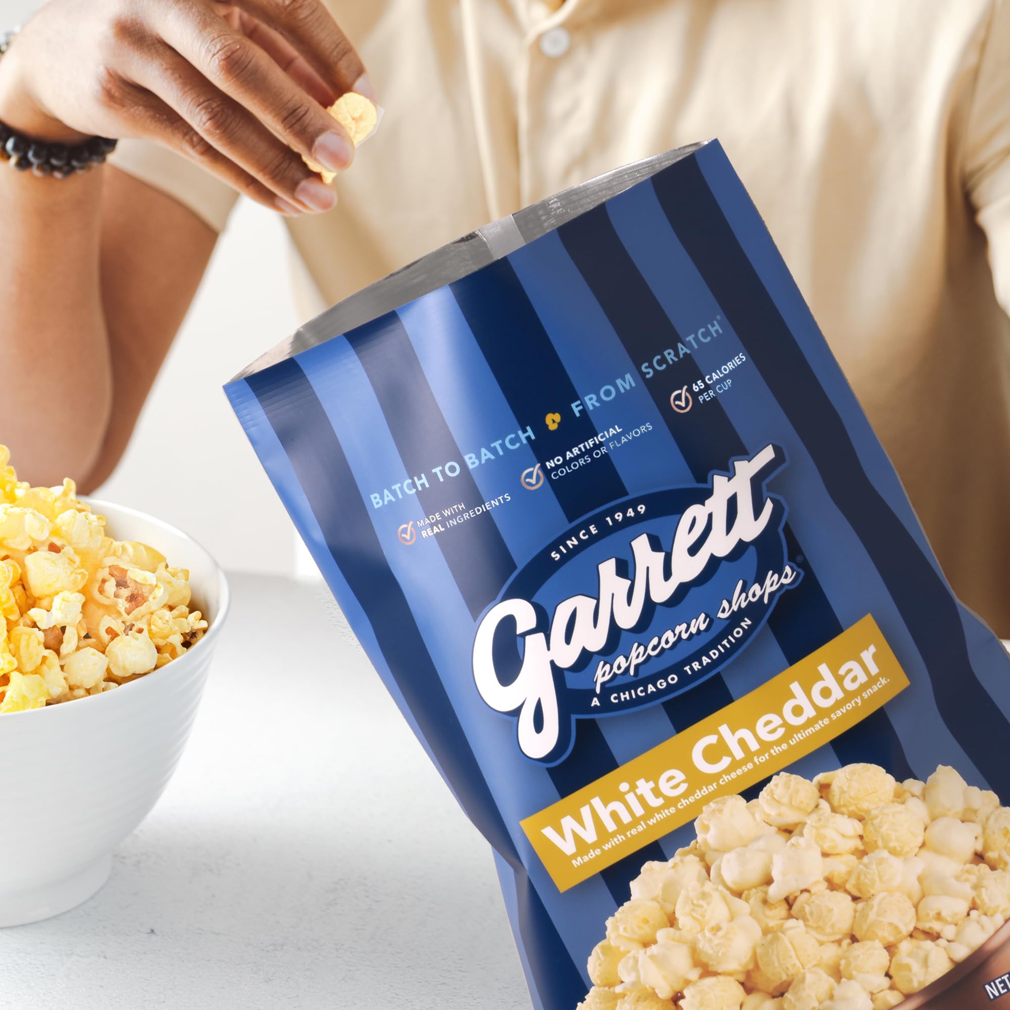 Product label highlights gluten-free and non-GMO kernels for Garrett Popcorn White Cheddar.
