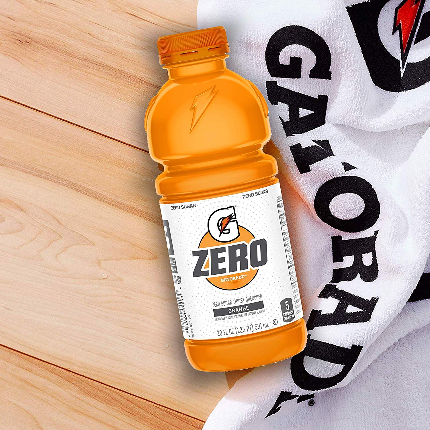 Pouring G Zero Orange to illustrate electrolyte replenishment during training