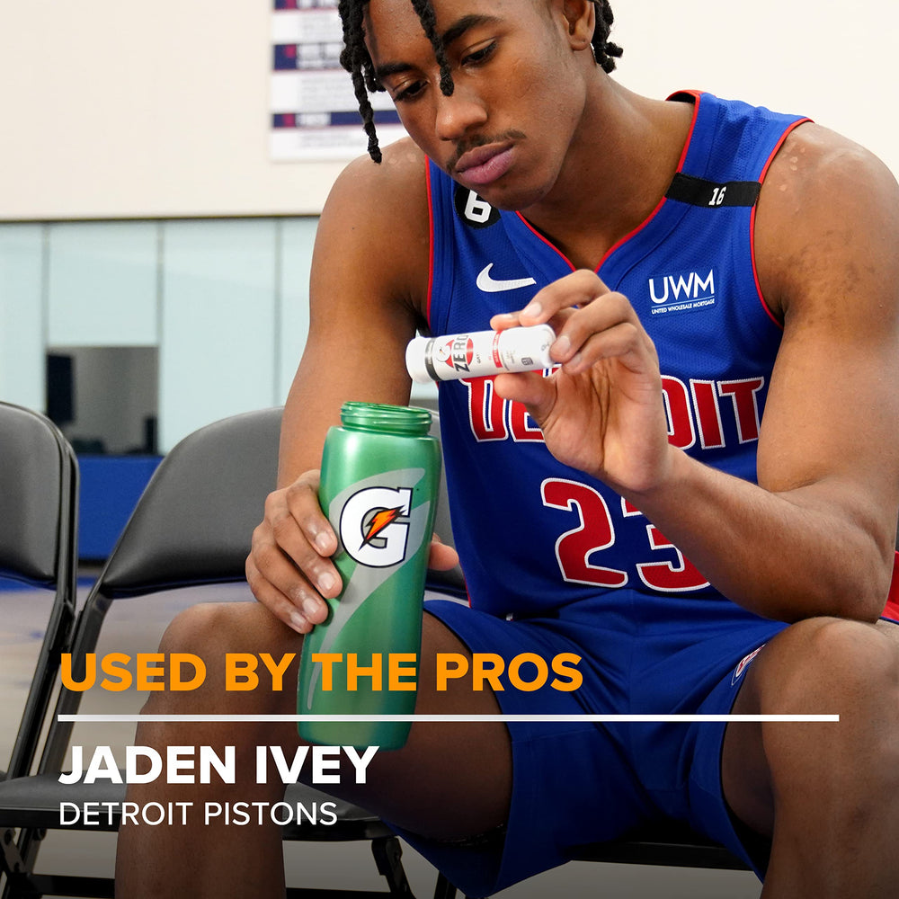 Athlete using a bottle with a dissolving tablet during practice.