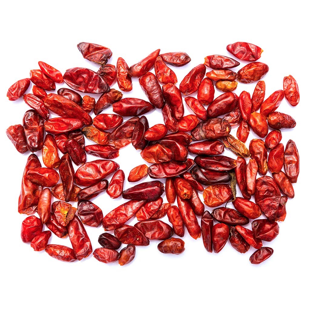 Close-up of dried pequin peppers highlighting their citrusy, smoky aroma.