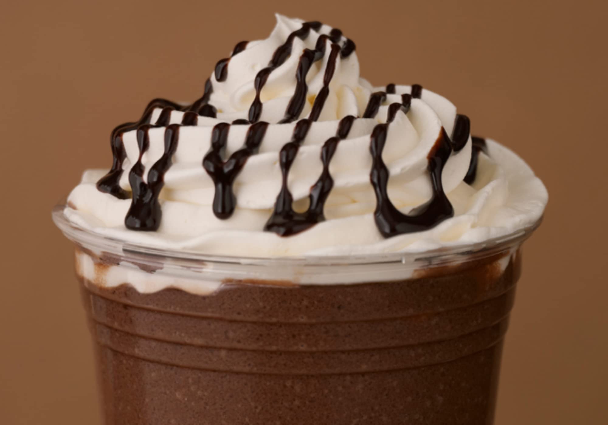 Close-up of Ghirardelli chocolate sauce bottle, highlighting convenient squeeze bottle 16 oz size.