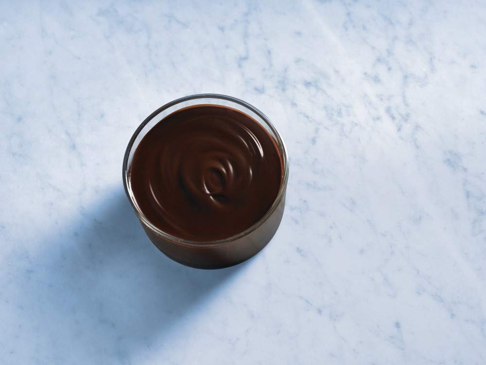 Ghirardelli chocolate sauce drizzle on a dessert plate for plating and topping