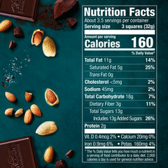 Close-up of chocolate square highlights roasted almonds and sea salt for a bold, balanced bite.