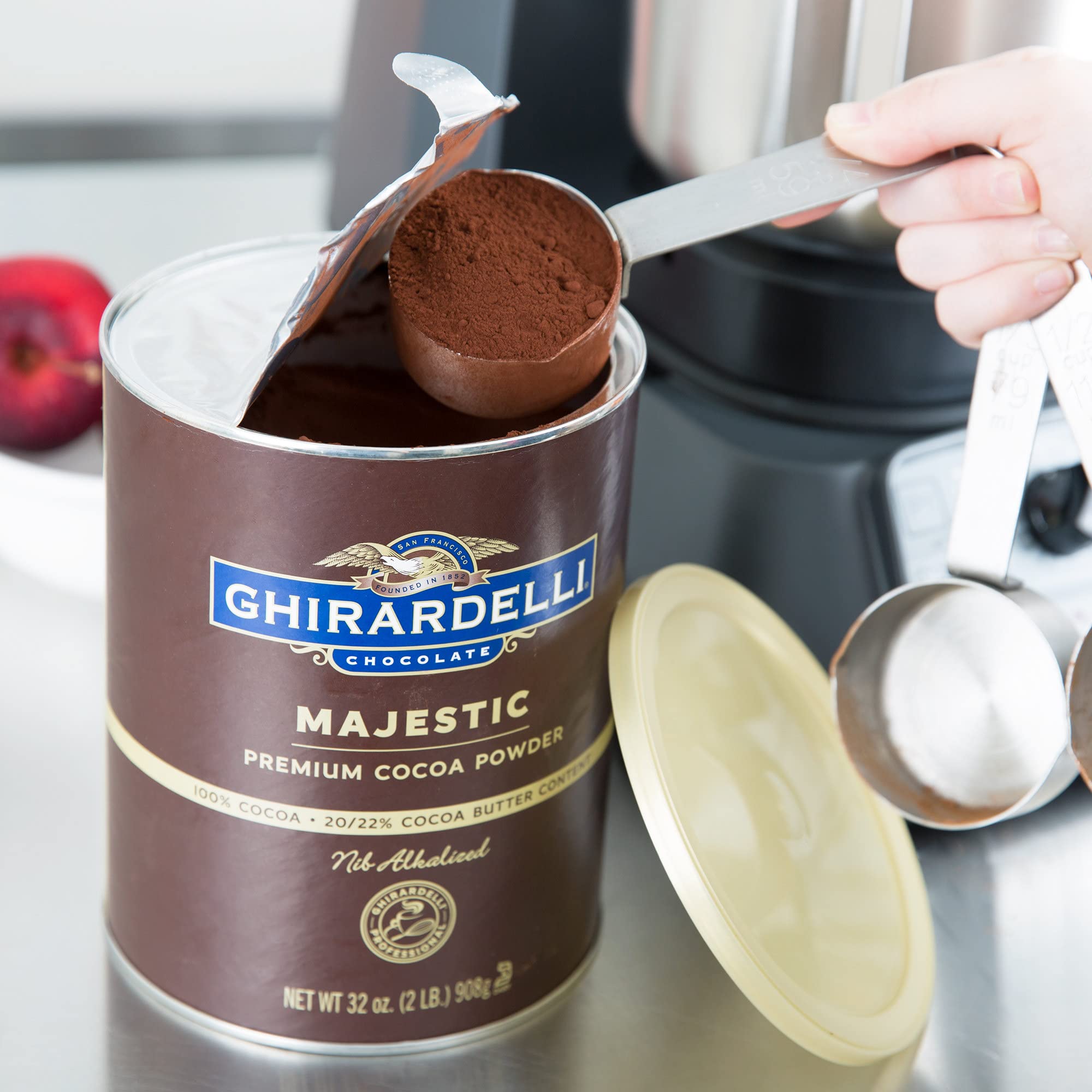 Ghirardelli Majestic Cocoa Powder poured over batter bowl for desserts
