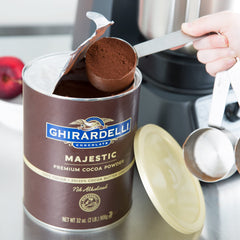Ghirardelli Majestic Cocoa Powder poured over batter bowl for desserts