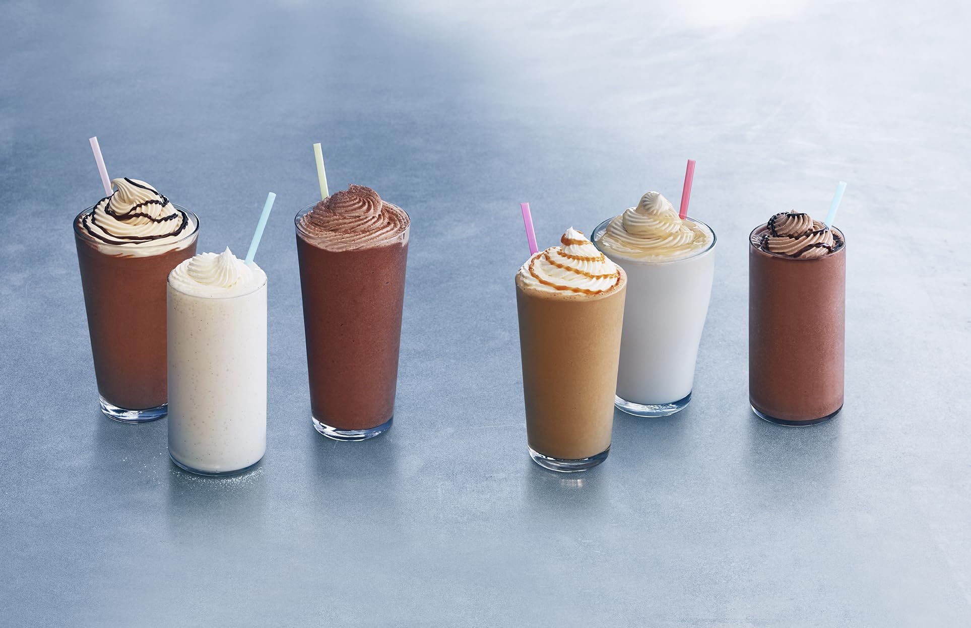Ghirardelli Vanilla Frappé Mix poured into a glass for a rich vanilla frappe.