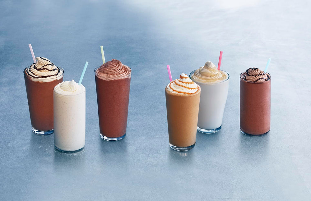 Ghirardelli Vanilla Frappé Mix poured into a glass for a rich vanilla frappe.