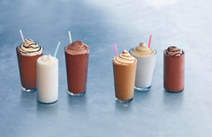 Ghirardelli Vanilla Frappé Mix poured into a glass for a rich vanilla frappe.