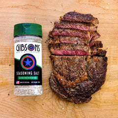 Gibsons Seasoning Salt being poured for quick, mess-free grilling seasoning.