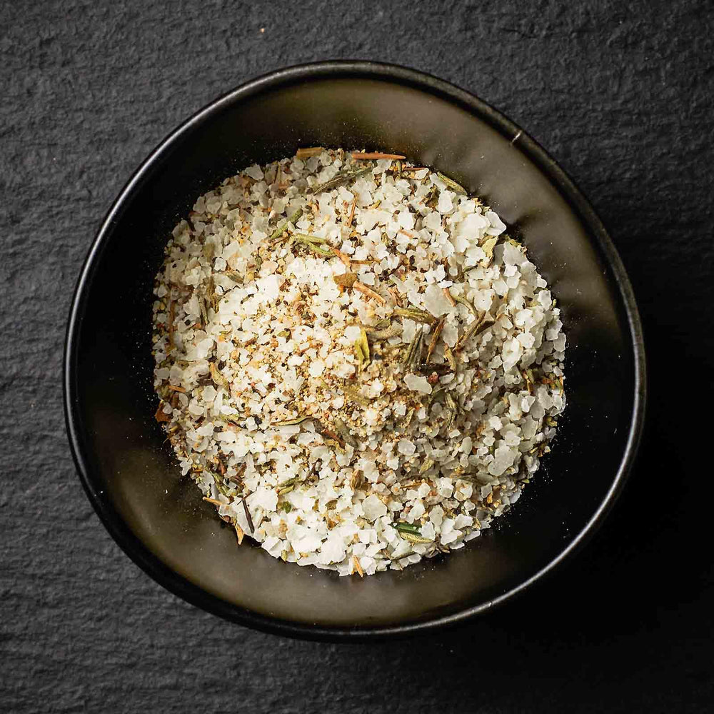 Gibsons Steakhouse Seasoning Salt on a steak enhances savory crust and aroma.