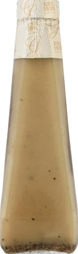 Champagne Dressing on a dining table with greens and bread.