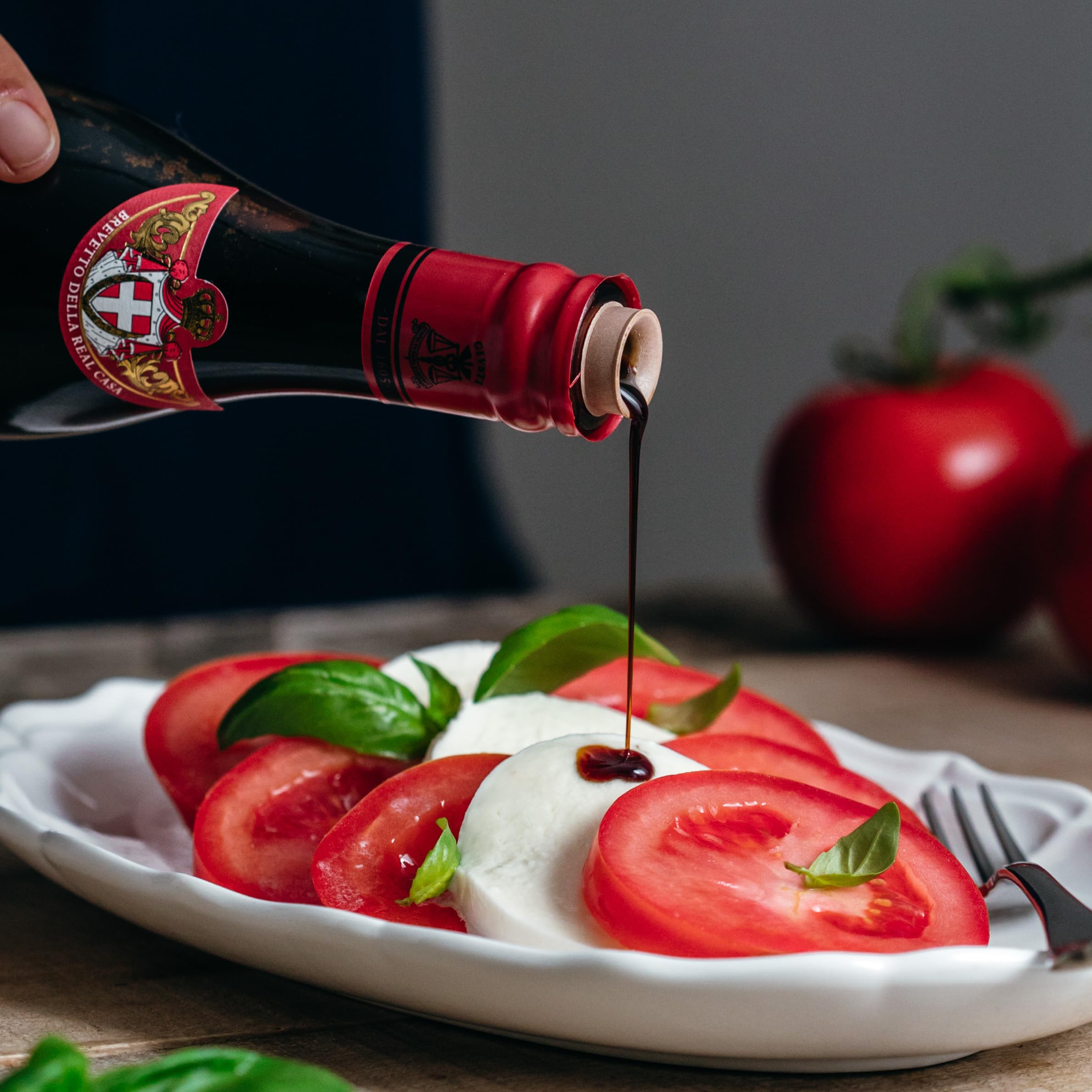Giusti balsamic on a plate with greens and fruit