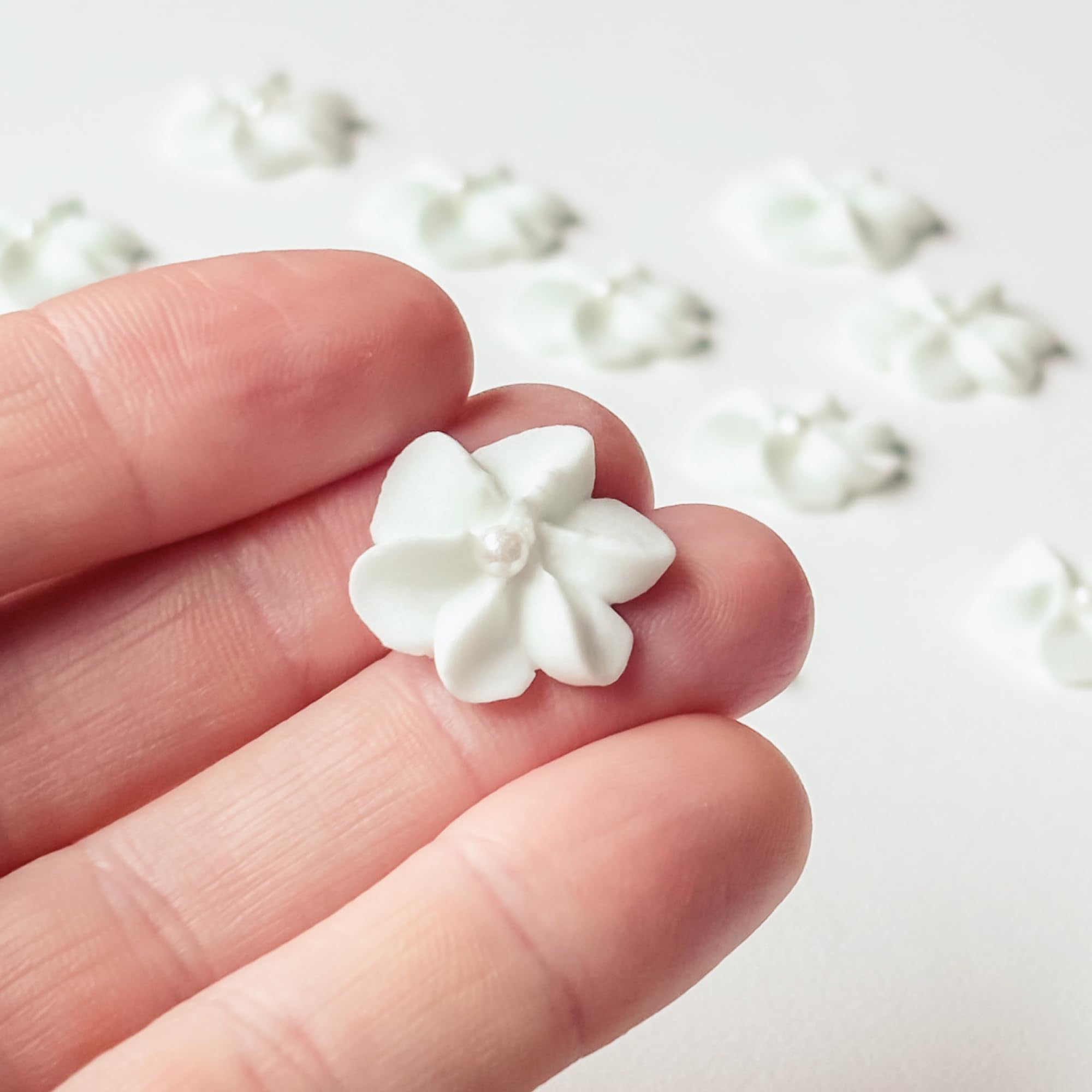 Global Sugar Art mini royal icing flowers in white with pearls for elegant wedding cupcakes.