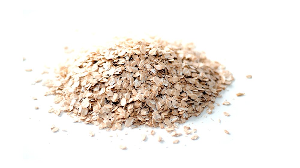 Pouring Gluten-Free Prairie Oatmeal into a pot for warm cereal