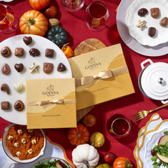 Godiva white chocolate pieces in a gold ribbon box for elegant gifting.