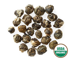 Golden Moon Tea Jasmine Dragon Pearls close-up; pearls unfurling release fragrance during steep.